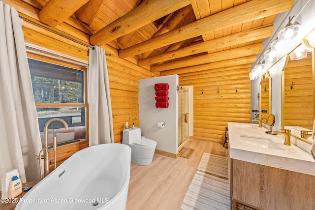 3 Hazel Lake Dr, Cimarron, CO 81220 - bathroom with double vanity, wood finished floors, rustic walls, a soaking tub, and toilet