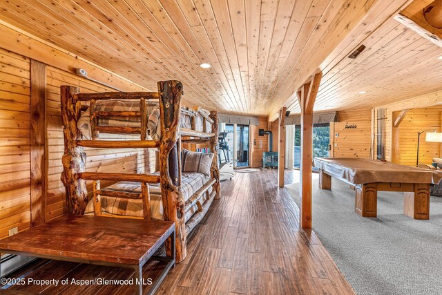 3 Hazel Lake Dr, Cimarron, CO 81220 - unfurnished bedroom with wood walls, wooden ceiling, billiards table, hardwood / wood-style floors, and a wood stove