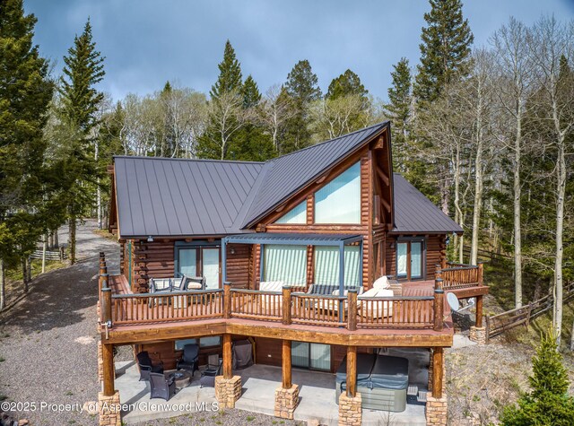 3 Hazel Lake Dr, Cimarron, CO 81220 - rear view of house with log exterior, a deck, metal roof, and a patio area