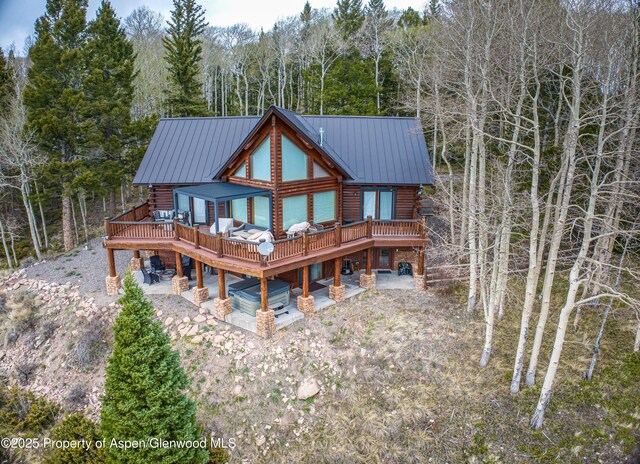 3 Hazel Lake Dr, Cimarron, CO 81220 - rear view of property featuring log exterior, a deck, a view of trees, and metal roof