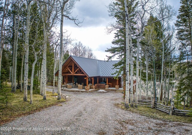 3 Hazel Lake Dr, Cimarron, CO 81220 - view of front of house featuring an outdoor living space, metal roof, gravel driveway, and a standing seam roof