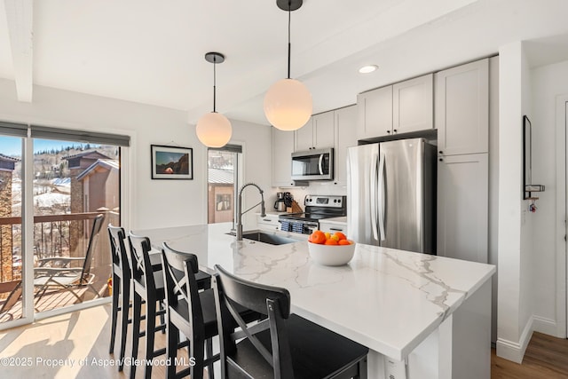 35 Upper Woodbridge Rd Unit 34Cd, Snowmass Village, CO 81615 - kitchen with appliances with stainless steel finishes, light stone countertops, an island with sink, decorative light fixtures, and recessed lighting
