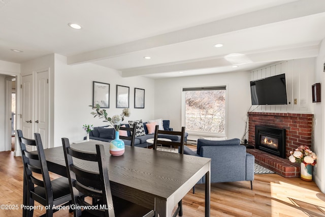 35 Upper Woodbridge Rd Unit 34Cd, Snowmass Village, CO 81615 - dining area featuring light wood-style floors, beam ceiling, recessed lighting, and a brick fireplace