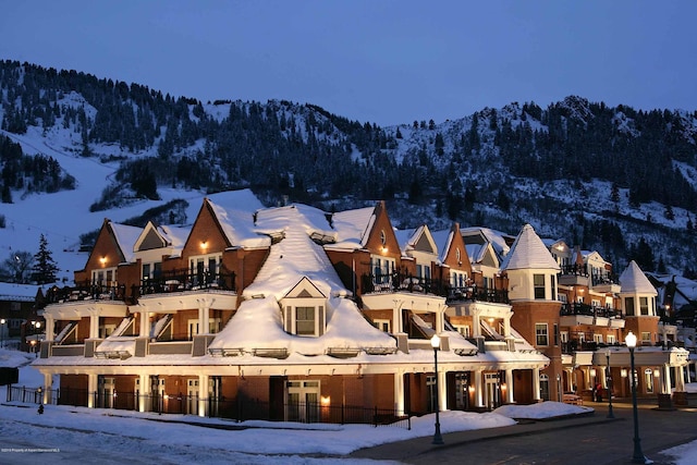 snow covered property featuring a mountain view