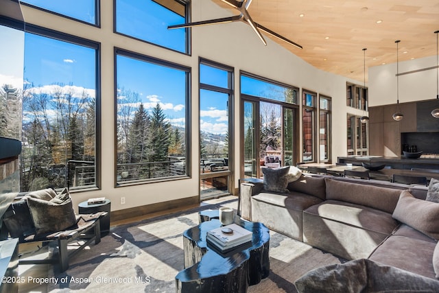 62 Bennett Ct, Aspen, CO 81611 - living area featuring wood finished floors, a towering ceiling, baseboards, and wood ceiling