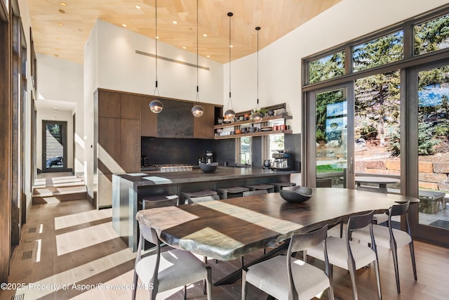 62 Bennett Ct, Aspen, CO 81611 - kitchen featuring a high ceiling, light wood finished floors, healthy amount of natural light, white cabinets, and recessed lighting