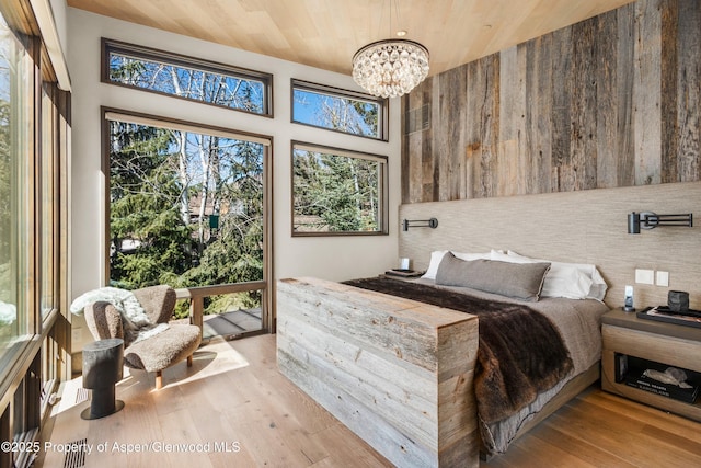 62 Bennett Ct, Aspen, CO 81611 - bedroom featuring a chandelier, wood-type flooring, and wood ceiling
