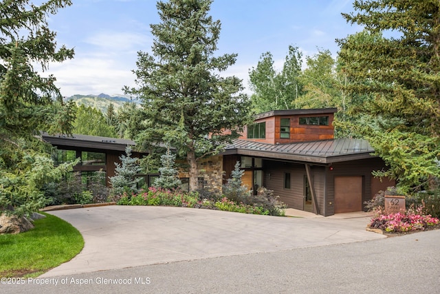 62 Bennett Ct, Aspen, CO 81611 - modern home with a standing seam roof, metal roof, driveway, stone siding, and a garage