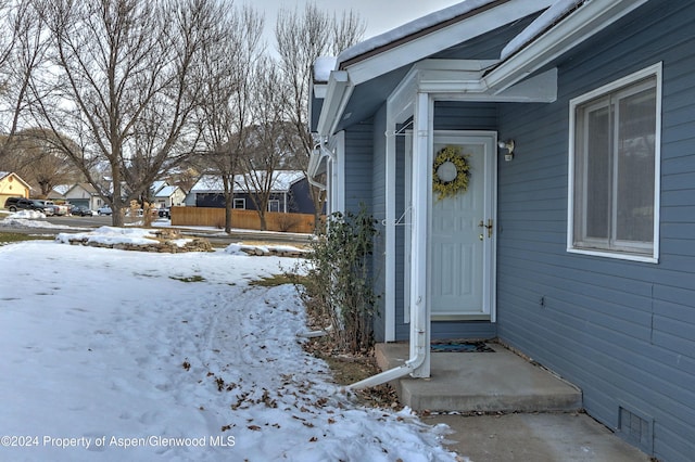 view of snow covered property entrance