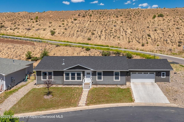 2432 Pioneer Way, Rifle, CO 81650 - view of front of house with concrete driveway, a garage, a front yard, and roof with shingles