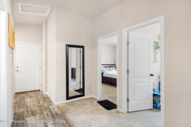 2432 Pioneer Way, Rifle, CO 81650 - hall with baseboards, attic access, wood finished floors, and carpet flooring