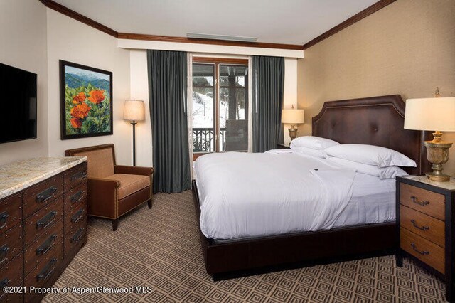 bedroom with carpet floors, ornamental molding, and access to exterior