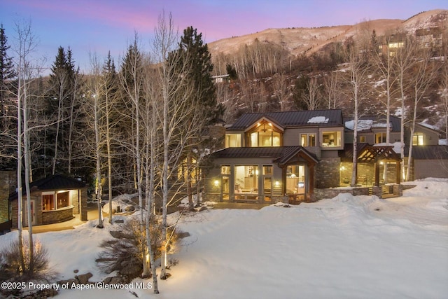 chalet / cabin with a standing seam roof, covered porch, a mountain view, and metal roof