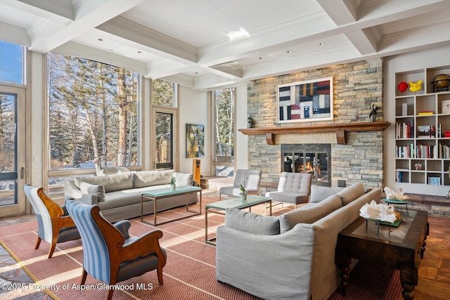 living room with a fireplace, ornamental molding, coffered ceiling, and beam ceiling