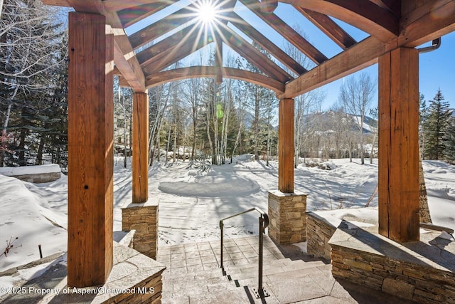 snow covered patio featuring a mountain view