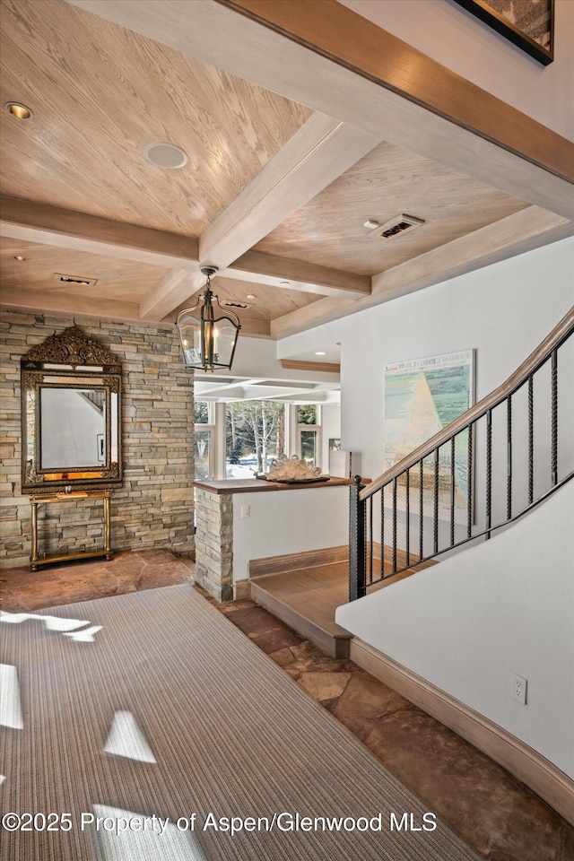 unfurnished living room featuring visible vents, stairway, a chandelier, and beamed ceiling