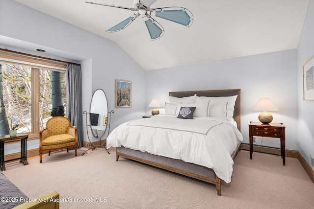 carpeted bedroom with vaulted ceiling, baseboards, and ceiling fan