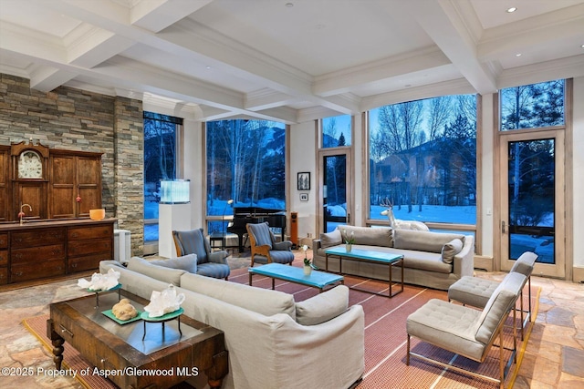 living room with stone tile flooring, coffered ceiling, and beamed ceiling