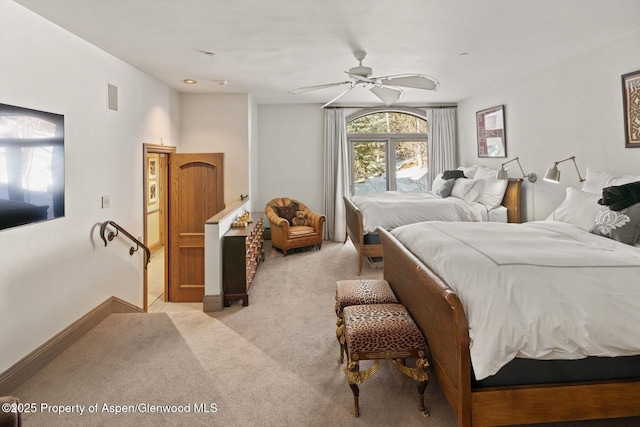 bedroom featuring baseboards, visible vents, ceiling fan, and light colored carpet