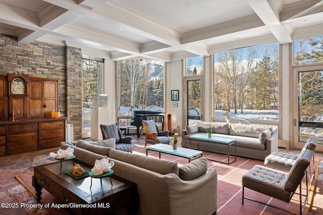 living area with coffered ceiling and beamed ceiling