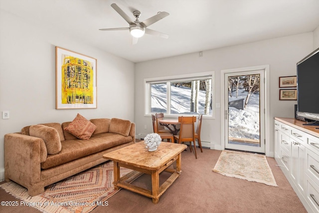 living room with light colored carpet, ceiling fan, and baseboards