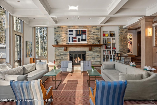 living room with coffered ceiling, beam ceiling, and a stone fireplace