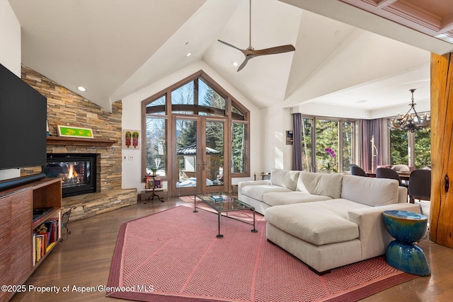 645 Willoughby Way, Aspen, CO 81611 - living area with wood finished floors, a stone fireplace, ceiling fan, a chandelier, and high vaulted ceiling