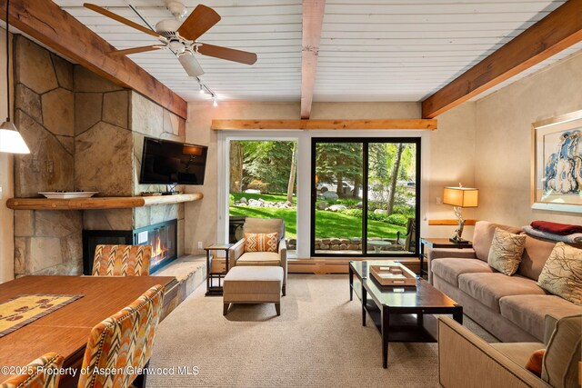 610 S W End St Unit D105, Aspen, CO 81611 - carpeted living area with a large fireplace, track lighting, ceiling fan, and wooden ceiling with exposed beams