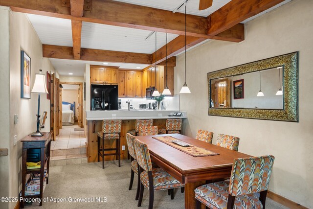 610 S W End St Unit D105, Aspen, CO 81611 - dining room with beamed ceiling, light carpet, ceiling fan, and baseboards