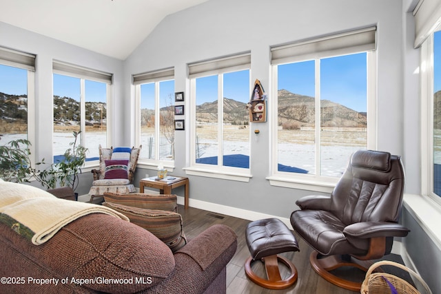 sunroom / solarium with a mountain view, plenty of natural light, and vaulted ceiling