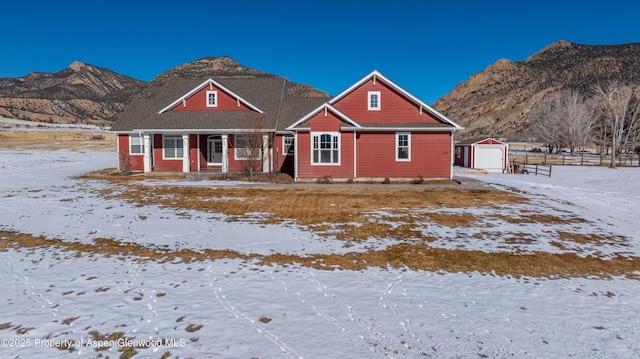 view of front of house with a mountain view, an outdoor structure, and a garage