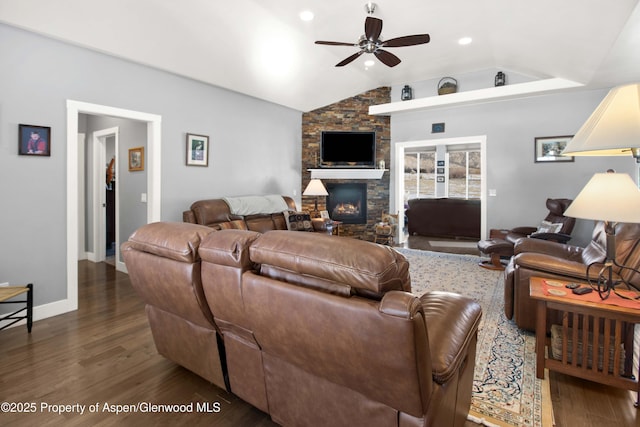 living room with ceiling fan, vaulted ceiling, a fireplace, and dark hardwood / wood-style floors