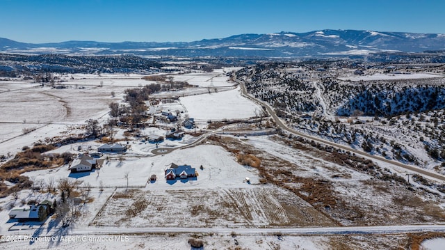 snowy aerial view with a mountain view