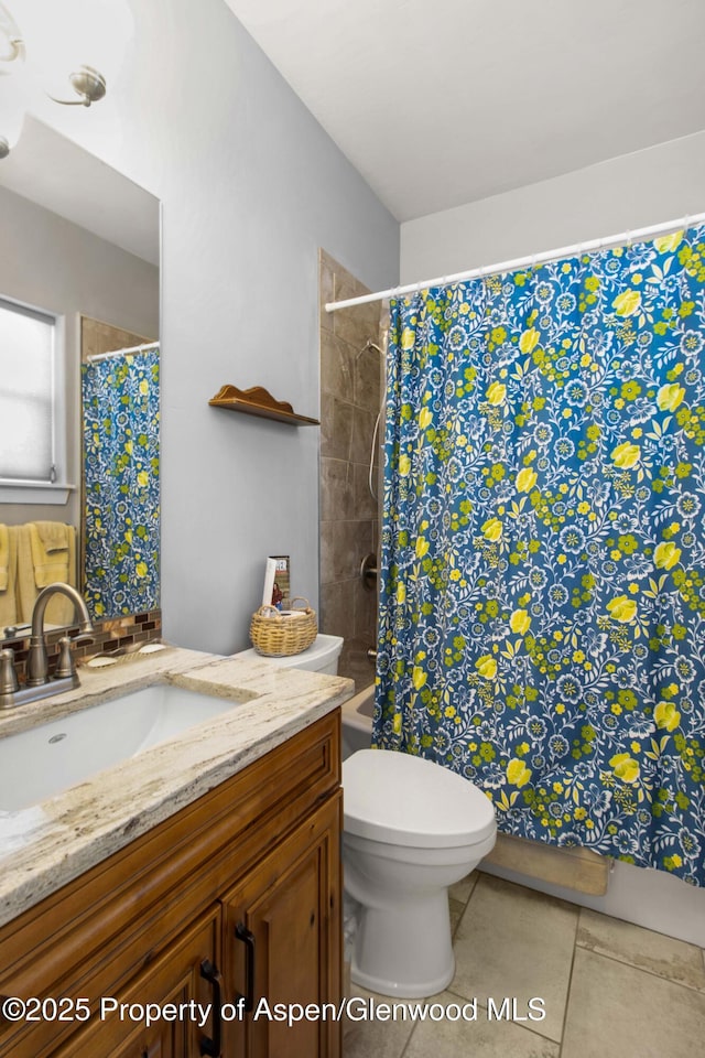 bathroom featuring toilet, tile patterned flooring, and vanity