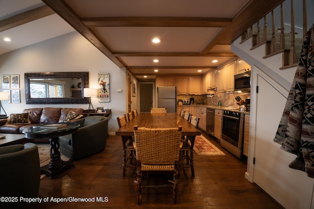 dining space featuring dark hardwood / wood-style flooring, sink, and vaulted ceiling with beams