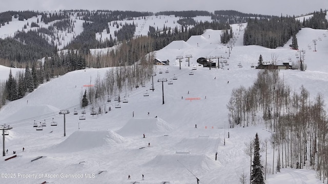 snowy aerial view featuring a mountain view