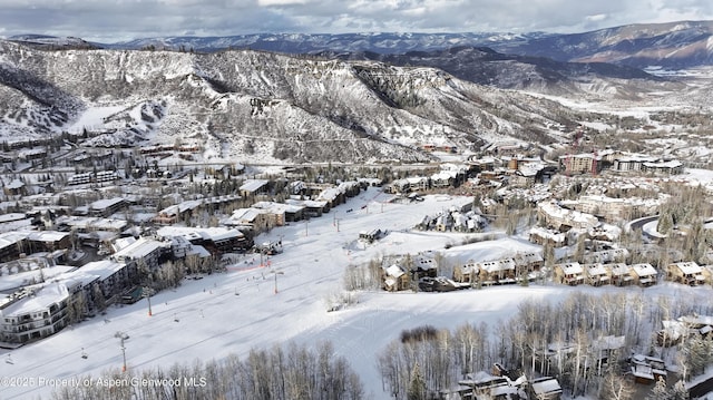 snowy aerial view with a mountain view