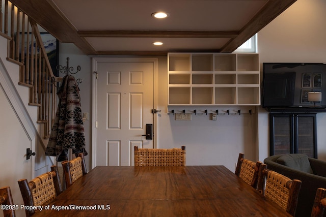 unfurnished dining area with beam ceiling