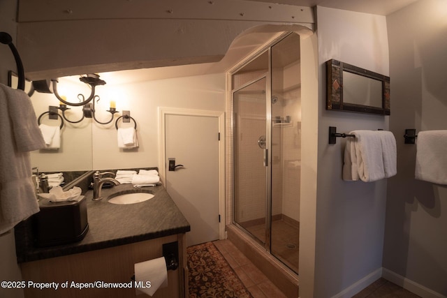 bathroom with tile patterned floors, vanity, and a shower with shower door