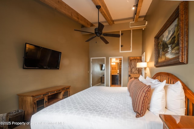 bedroom featuring beam ceiling and ensuite bath