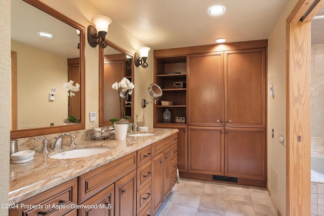 bathroom featuring tile patterned floors, vanity, and a relaxing tiled tub