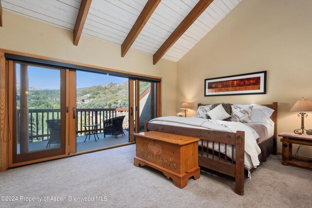 bedroom with access to outside, a mountain view, high vaulted ceiling, and light colored carpet