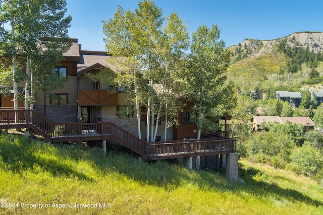 back of house with a deck with mountain view