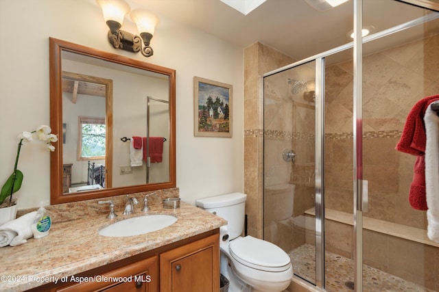 bathroom featuring vanity, toilet, and an enclosed shower