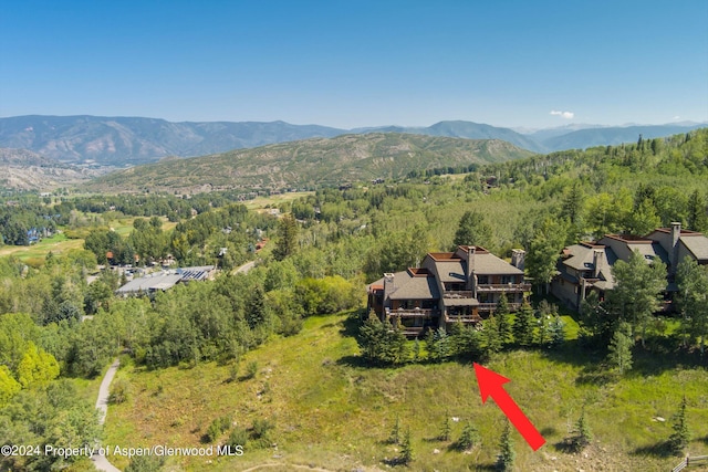 birds eye view of property with a mountain view