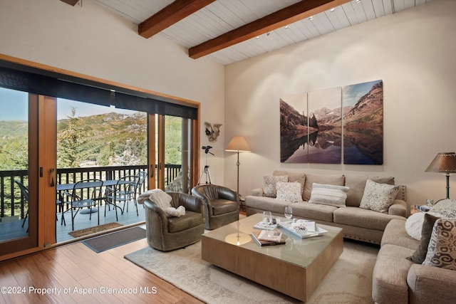 living room featuring beamed ceiling, wooden ceiling, and hardwood / wood-style flooring