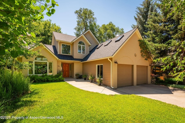 90 River Cv, Basalt, CO 81621 - traditional home featuring brick siding, a front yard, a shingled roof, and a garage