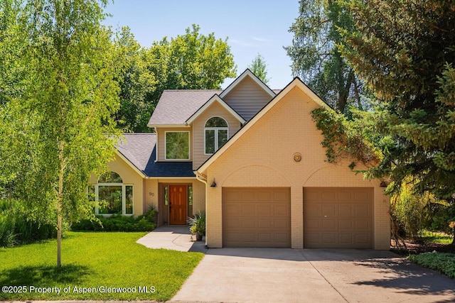 90 River Cv, Basalt, CO 81621 - view of front facade with driveway, brick siding, a front yard, an attached garage, and roof with shingles