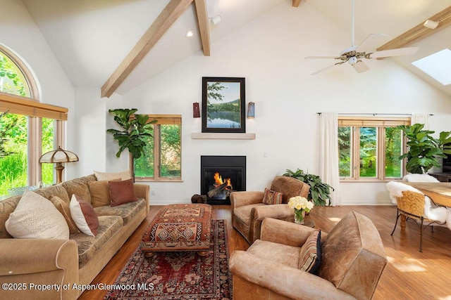 90 River Cv, Basalt, CO 81621 - living area featuring high vaulted ceiling, wood finished floors, beam ceiling, a glass covered fireplace, and a skylight