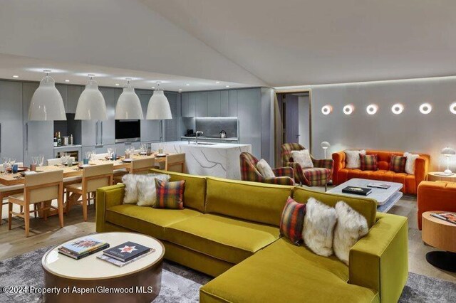 living room featuring sink and high vaulted ceiling